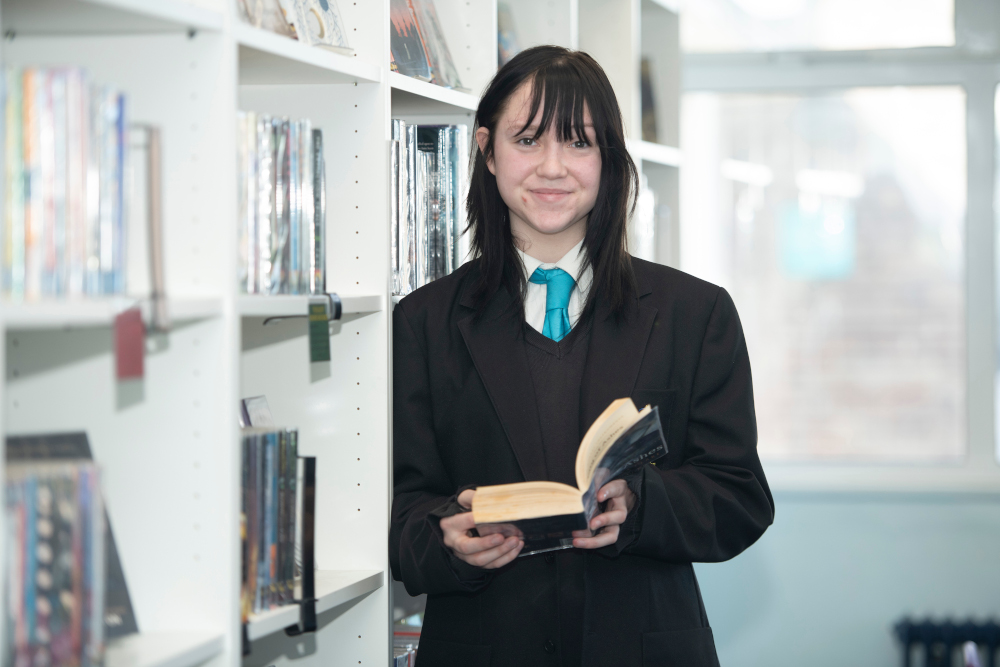 Student holding a Book from the Library Student holding a Book from the Library