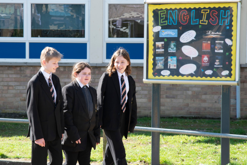 Students-Standing-by-English-Sign Students Standing by English Sign
