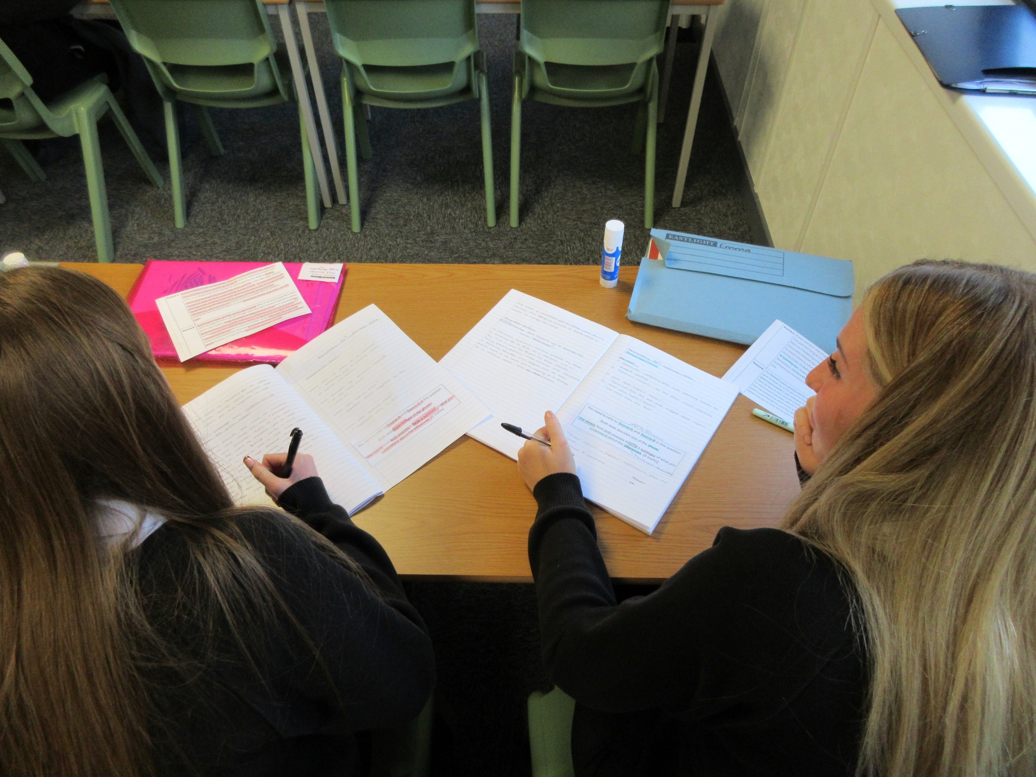 Students Studying Writing in Exercise Books