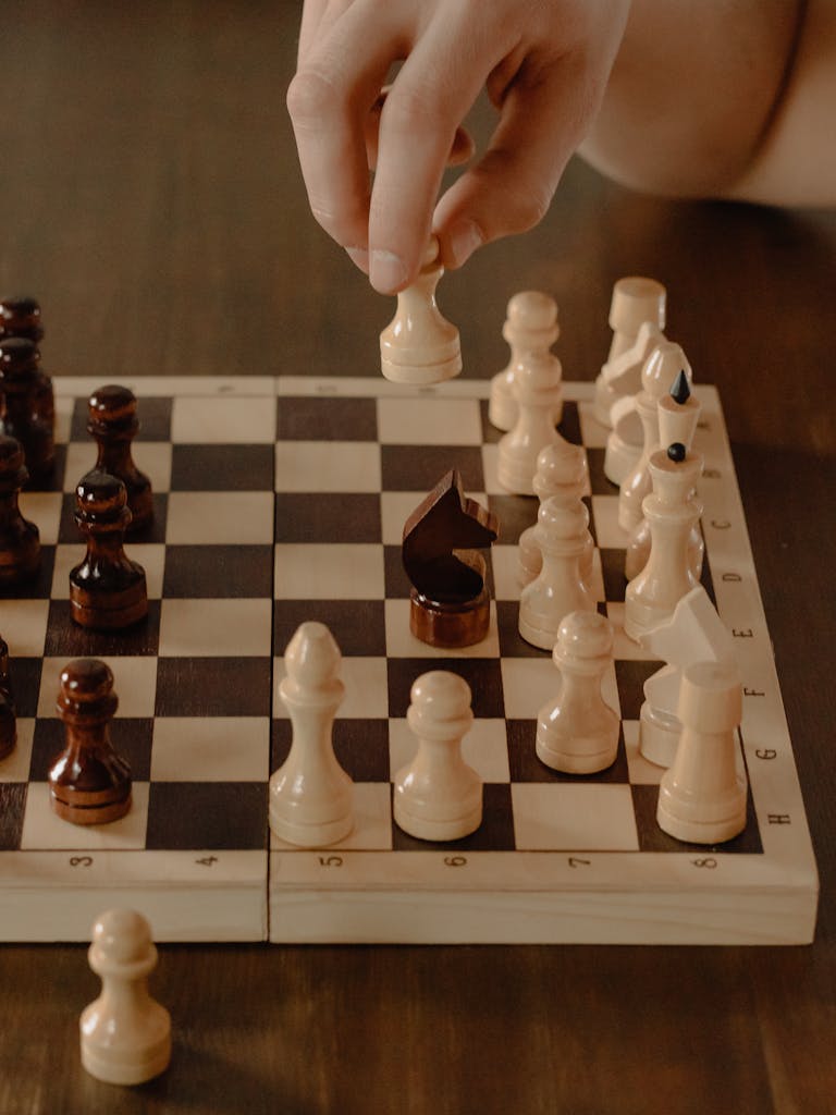 A player makes a strategic move on a chessboard for a winning game.